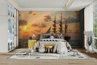 A wall mural of a sailboat at dusk.

