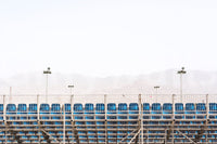 Blue seats fill row after row below pale mountains, an Eilat #30 wall mural GD4803
