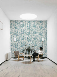 An installation view of the wallpaper being hung on a wall.


