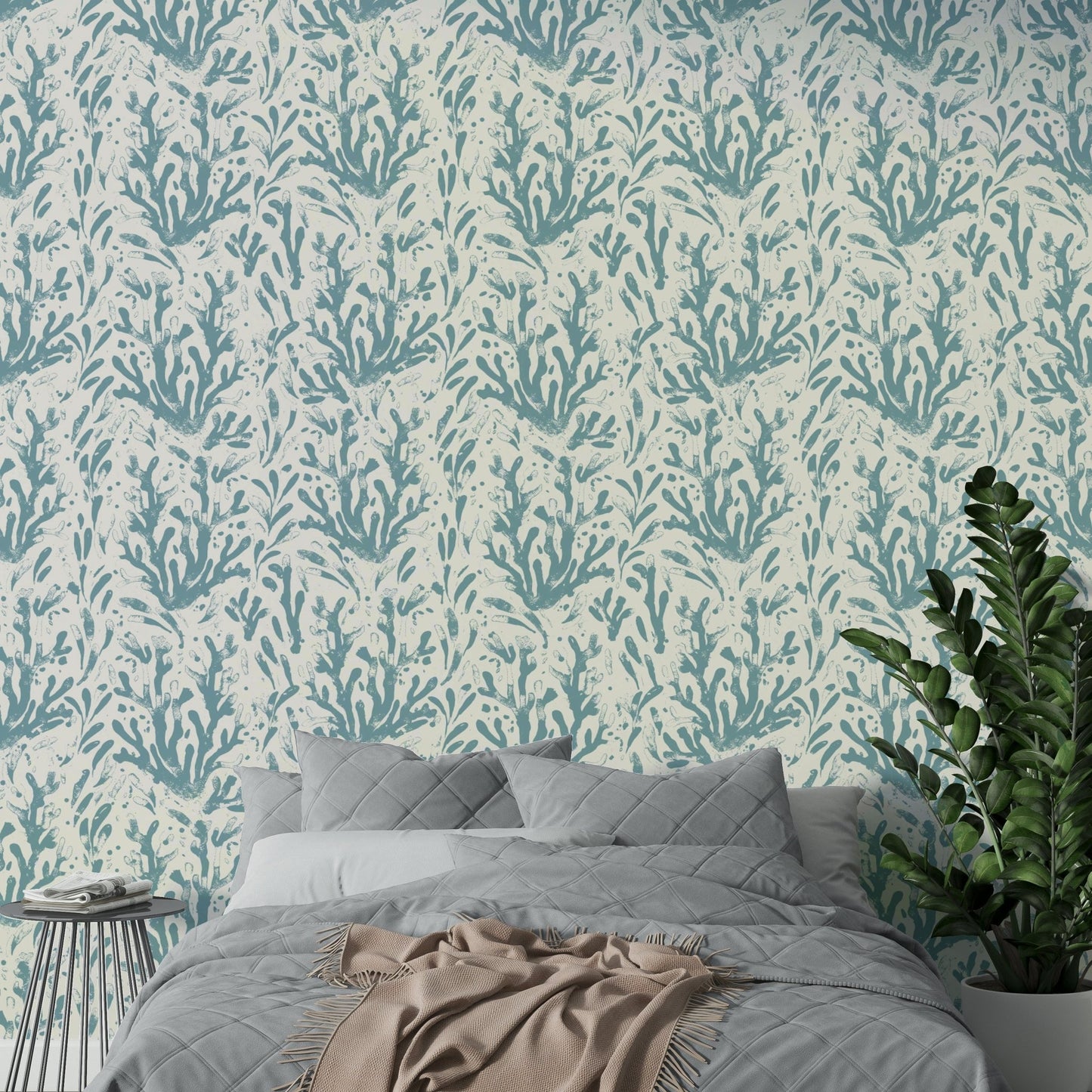 The sea life wallpaper applied to a wall behind a bed.

