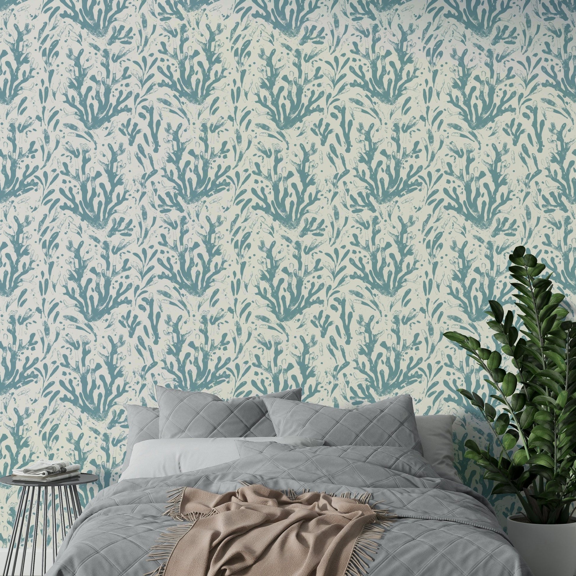 The sea life wallpaper applied to a wall behind a bed.

