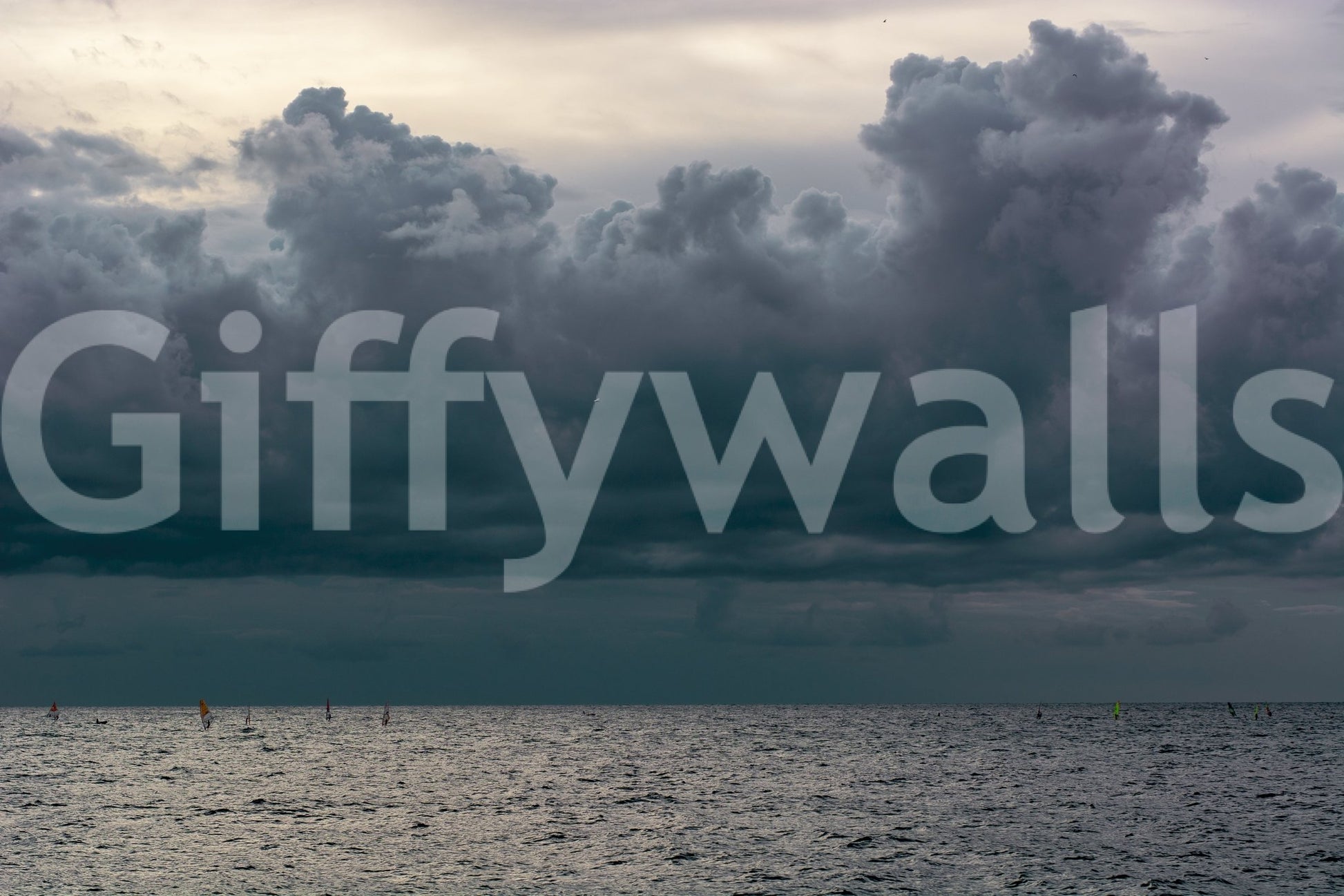 Colorful sails dot the far water below gray cloud in this Seaside #8 wall mural GD4784
