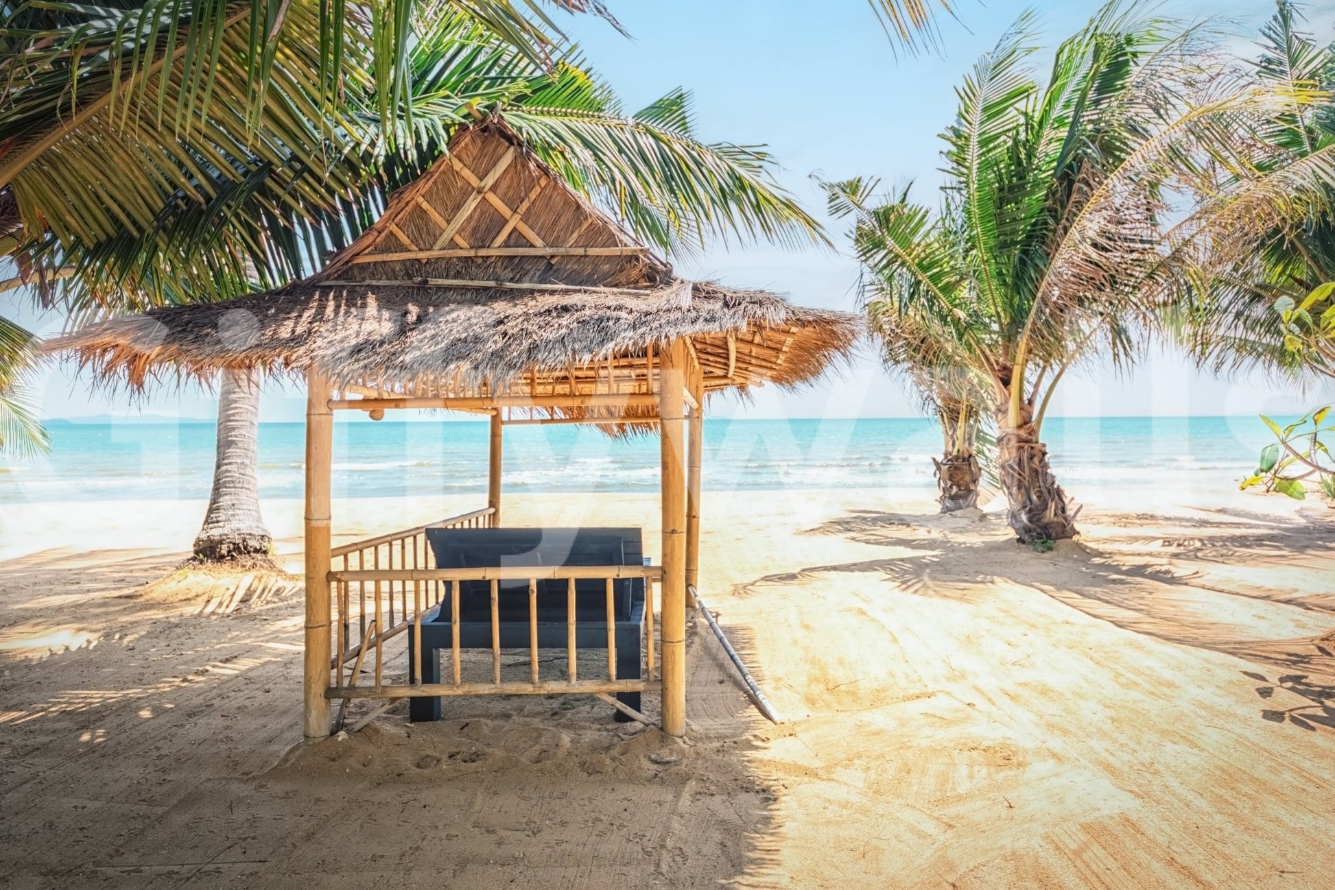 Peaceful shore view wall mural with a rustic bamboo cabana.