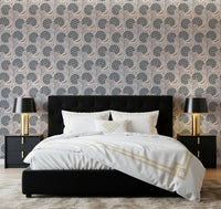 Bedroom setup with Serene Blooms Wallpaper behind a dark upholstered bed