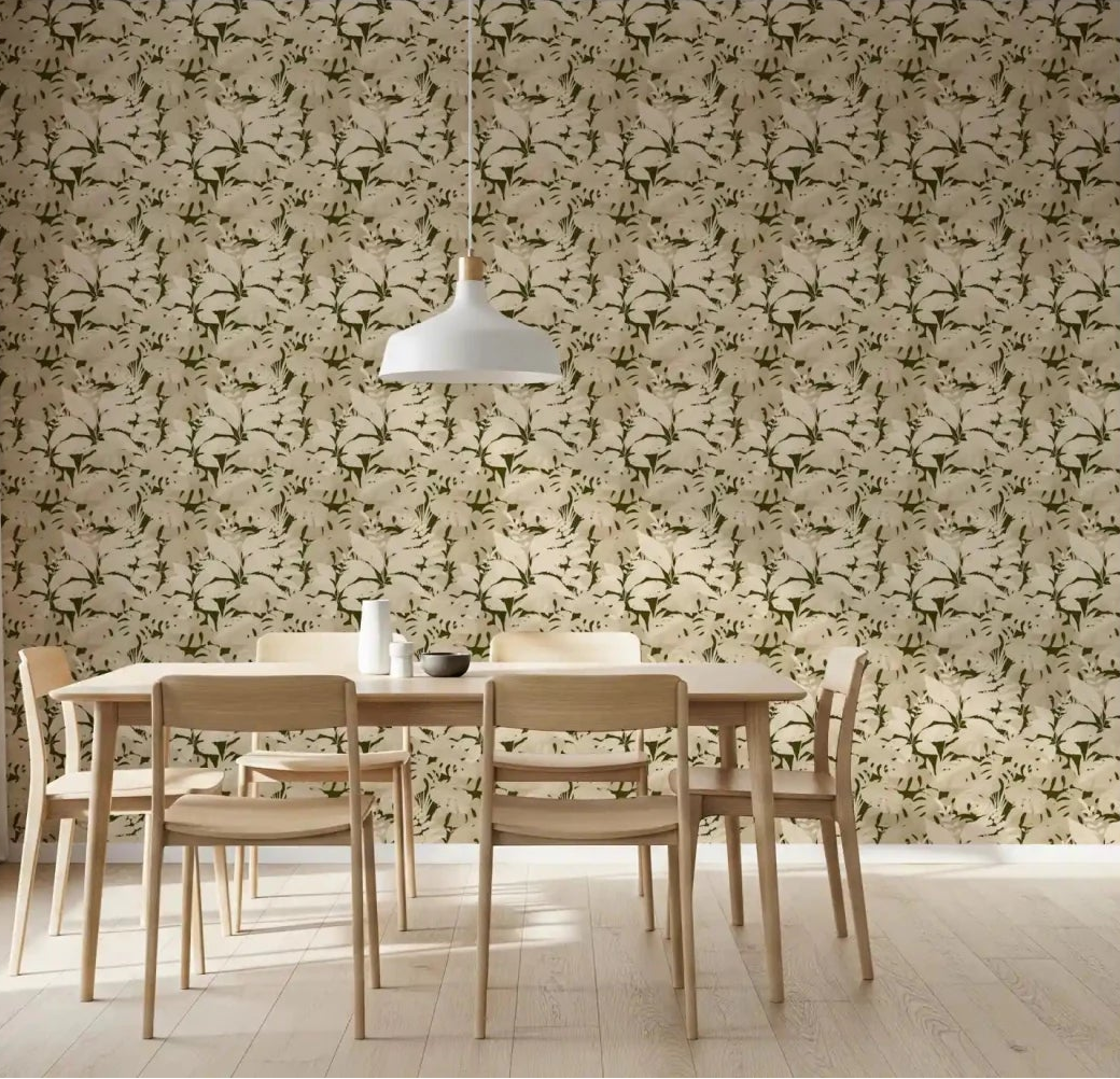 Serene Botanical Rustic Monstera Wallpaper in a light dining room with wood chairs