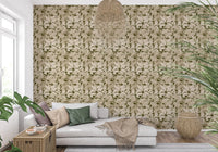 Soft beige leaf wallpaper behind a cream sofa in a calm Serene Botanical lounge