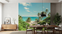 Dining room with Serene Coastal Paradise Wall Mural beside a wooden table and greenery