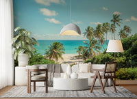 Bright sitting area with Serene Coastal Paradise Wall Mural behind a table and woven chair