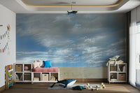 The colors are earthy greens and browns, contrasting with the colors of the sky.

