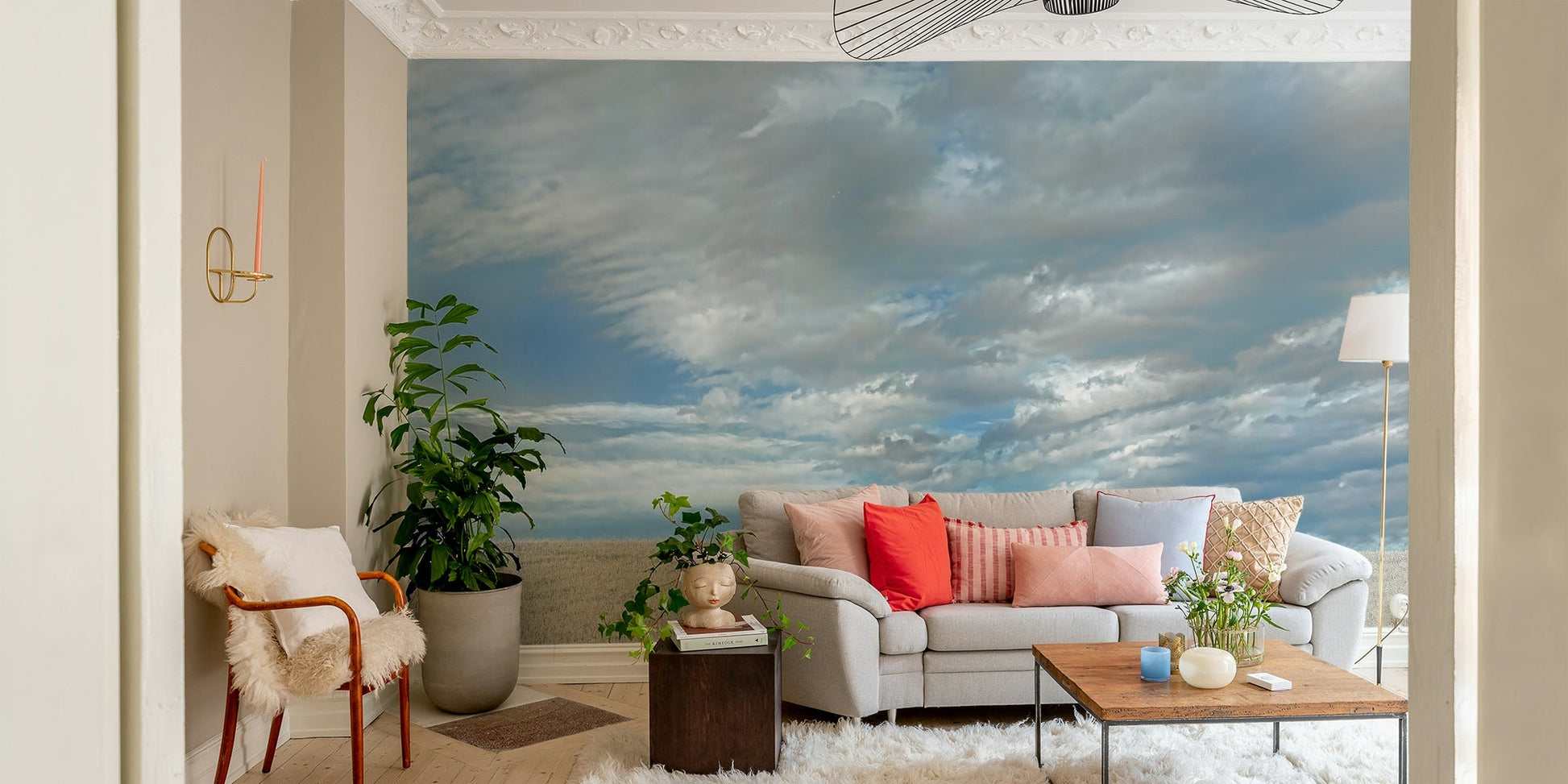 A photo-realistic wall mural of rolling fields under a dramatic sky.

