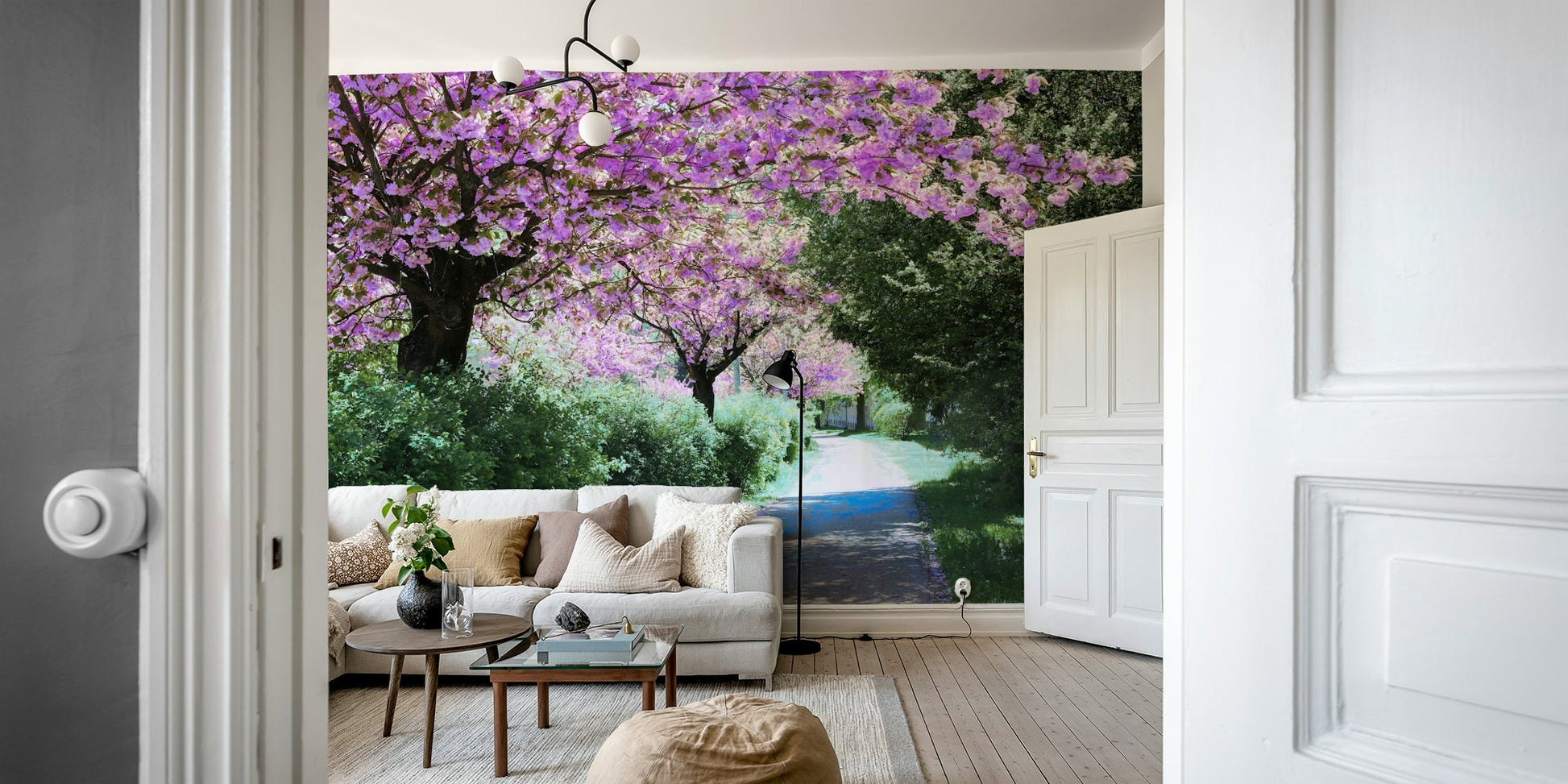 The image shows a path winding through a garden of pink and white flowers.

