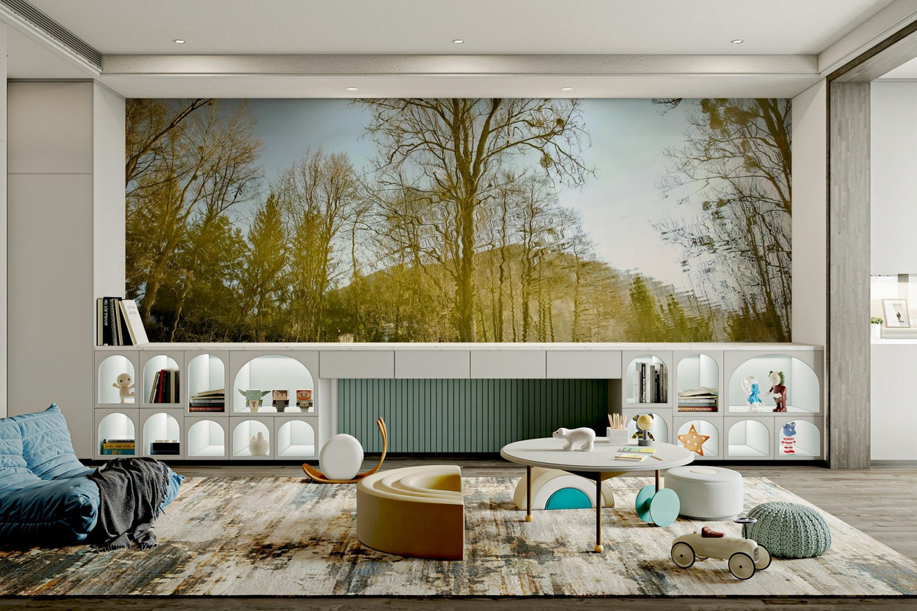 A photo-realistic wall mural showing trees reflected in tranquil water.