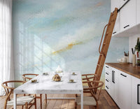 Fresh watercolor washes of the Serene Sky Whisper Wall Mural brighten a white kitchen area.
