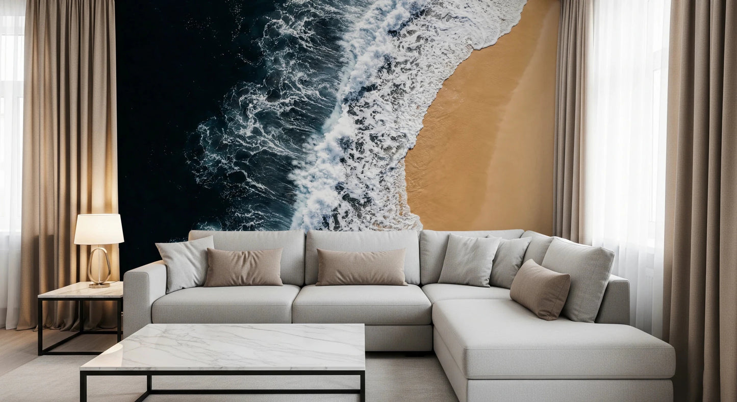 Soft lounge corner framed by Shoreline Wall Mural and a dramatic ocean edge
