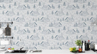 Whimsical smokey cabins wallpaper in blue for playful, cozy rooms.
