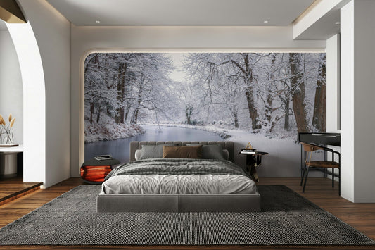 A beautiful serene scene of a snowy canal in a town.

