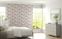 Detail of the soft blush-pink hues in the Soft Mosaic tile wallpaper.