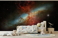 Celestial wallpaper with gold stars for a bedroom feature wall.