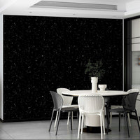 The room's lighting is dim, which complements the wallpaper.
