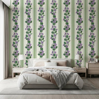 Bedroom wall styled in Stripes and Violets wallpaper with vertical violet blooms