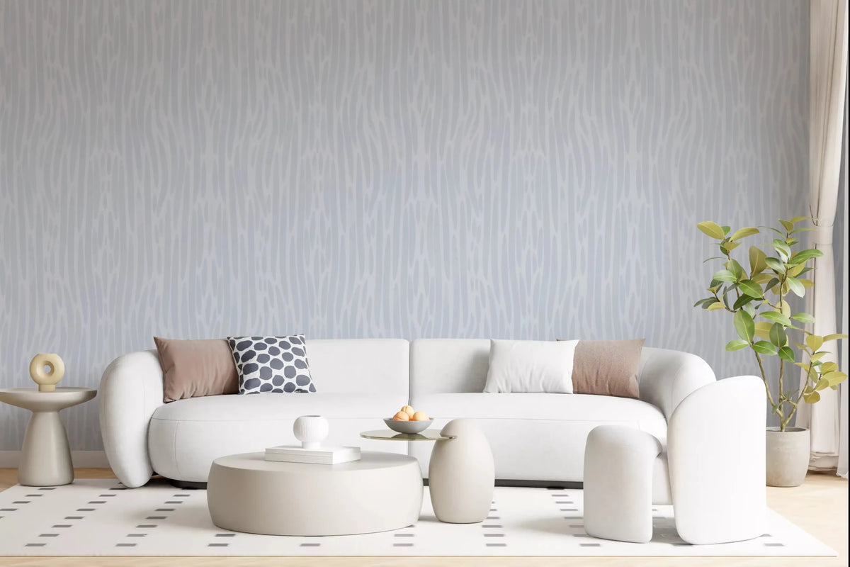 Living room with cream linen sofa and oak side table styled against pale grey watercolor strokes wallpaper GD9522
