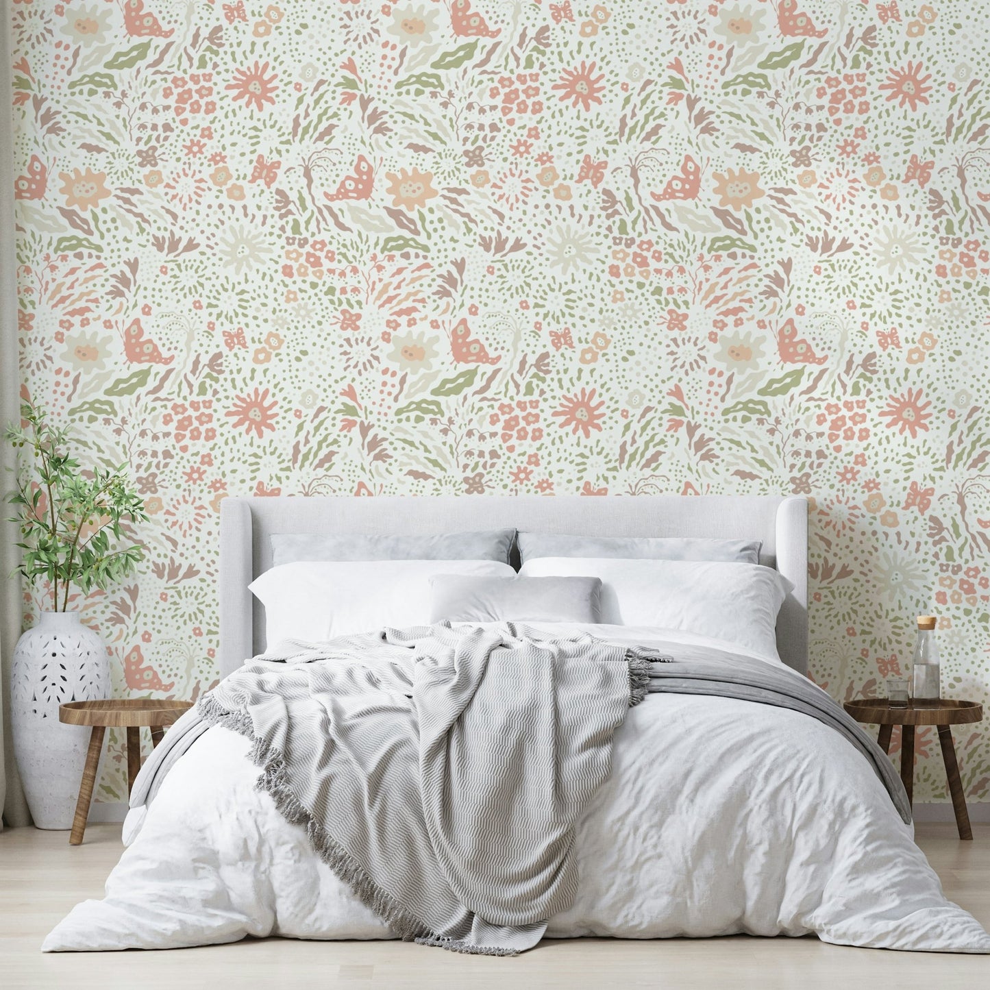 The wallpaper is on the wall behind a white baby crib.
