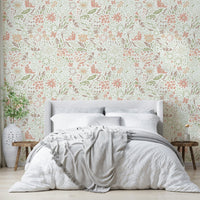 The wallpaper is on the wall behind a white baby crib.
