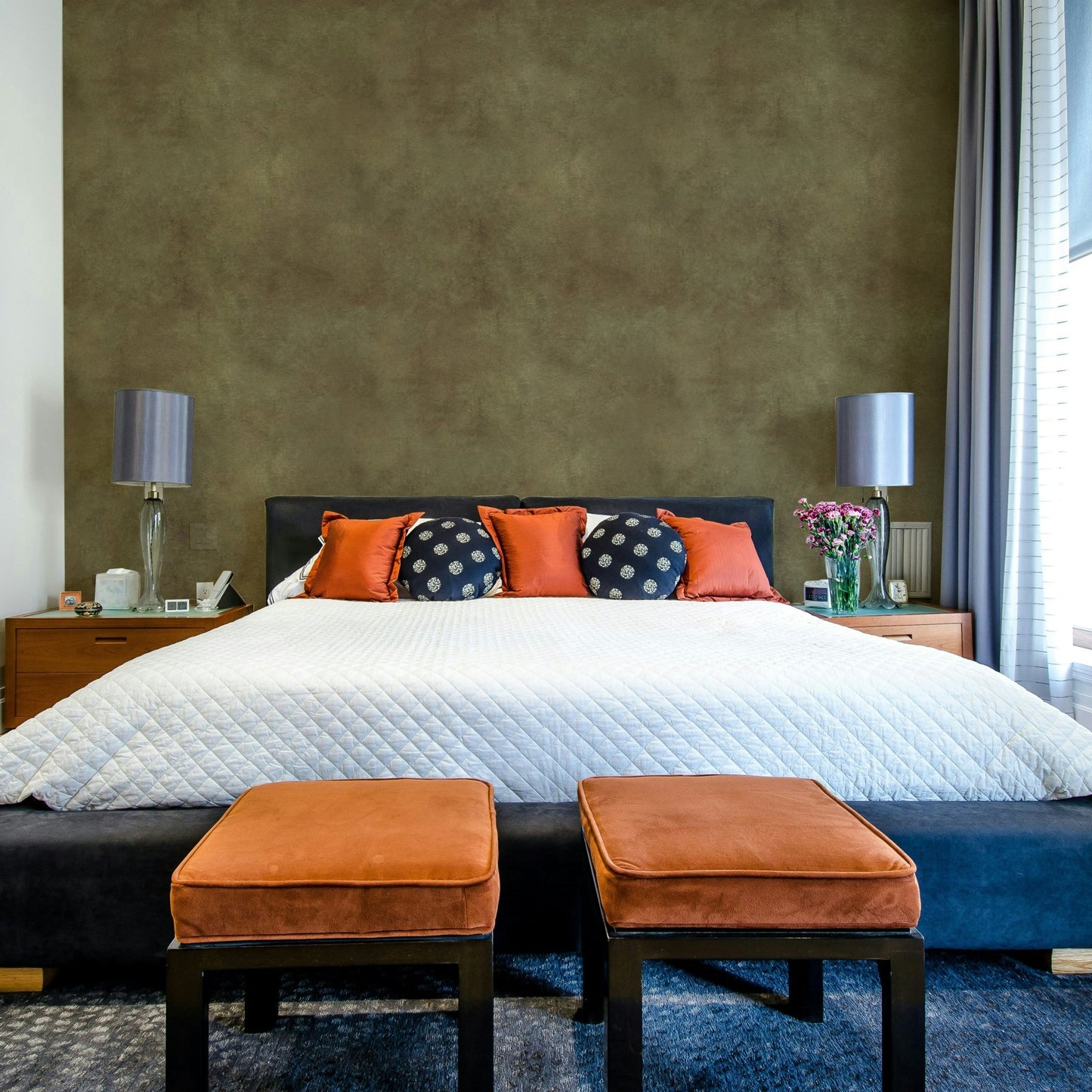 Suede-effect wallpaper in deep olive green shade.

