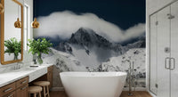 A peaceful mountain range mural on decorative wallpaper.