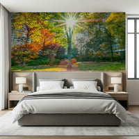 Scenic forest wall mural with yellow light beams in a hallway.