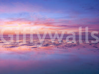 Soft dawn hues glow in Sunrise at Beach Wall Mural above quiet rippled waterline, GD8626