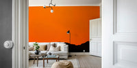 A peaceful mountain landscape mural on decorative wallpaper.

