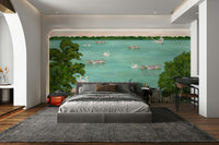 The water has a soft reflection of the trees and swans.
