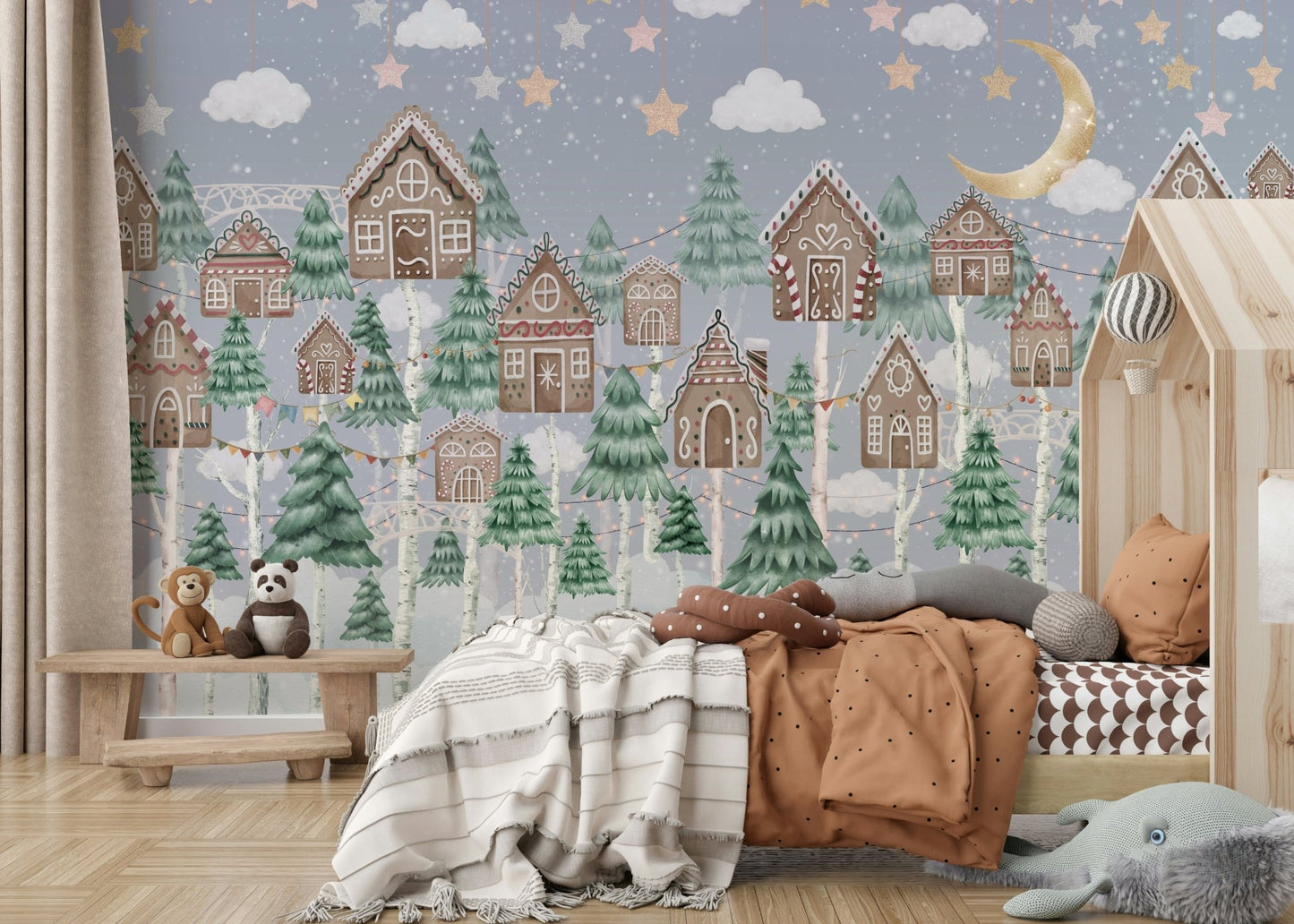 Snow is falling softly over the village and trees.

