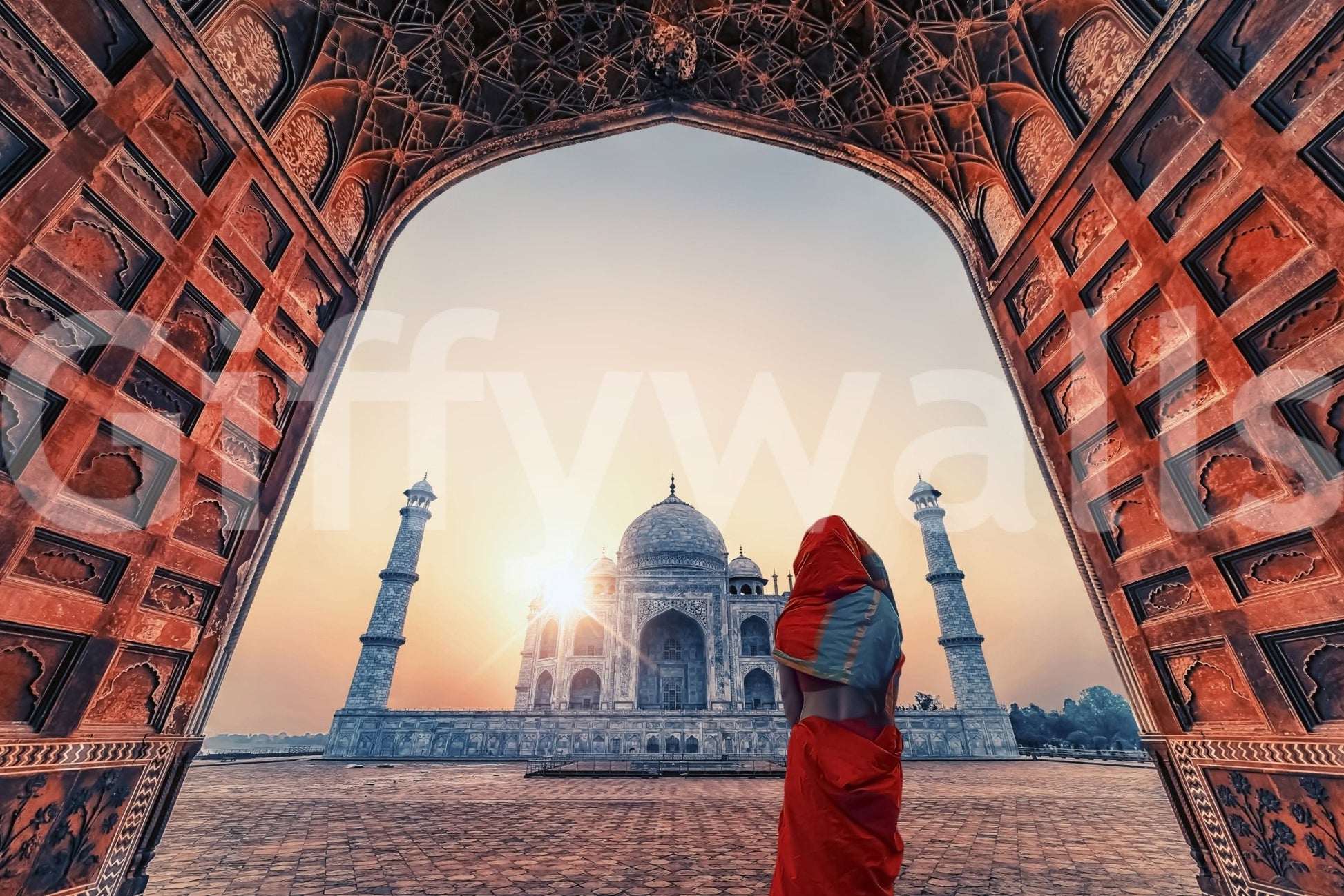 Through a red stone gateway, the sunset Taj wall mural shows domes and tall minarets