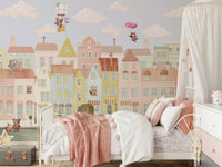 Teddy's Town Wall Mural behind a wooden toy chest in a nursery wallpaper.