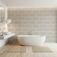 Close-up of the subtle texture on beige brick wallpaper design.