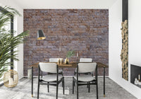 A hand applying the Textured Brick Wall realistic brick mural.