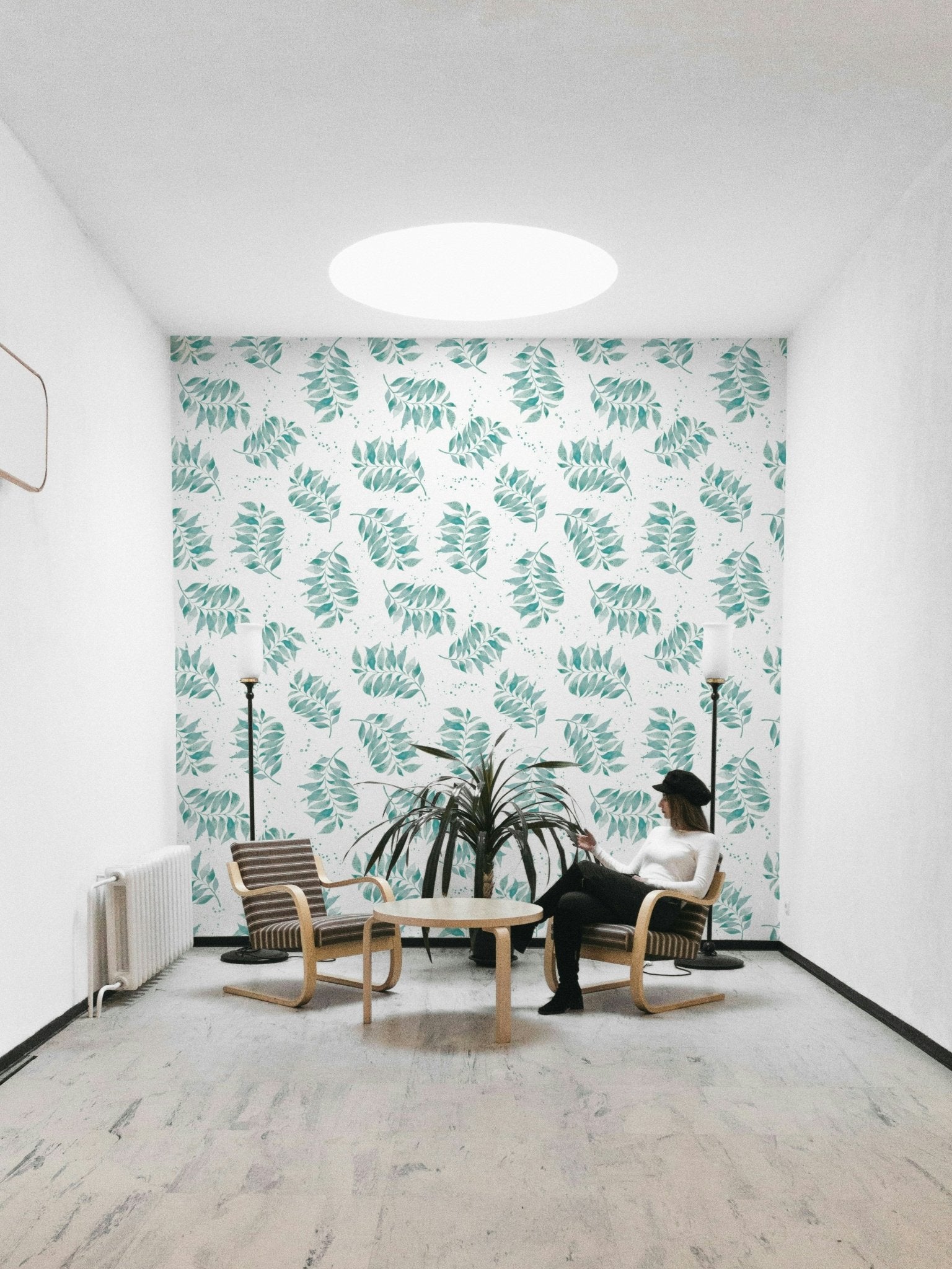 Mural wallpaper featuring tossed palm leaves in aqua

