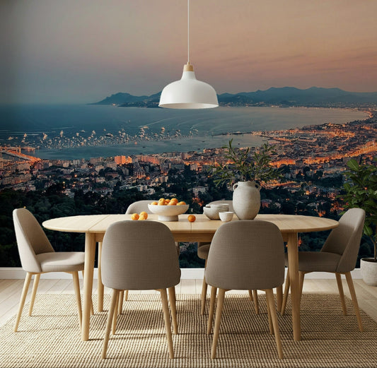 Dining room with The Bay of Cannes Wall Mural and a glowing coastal skyline