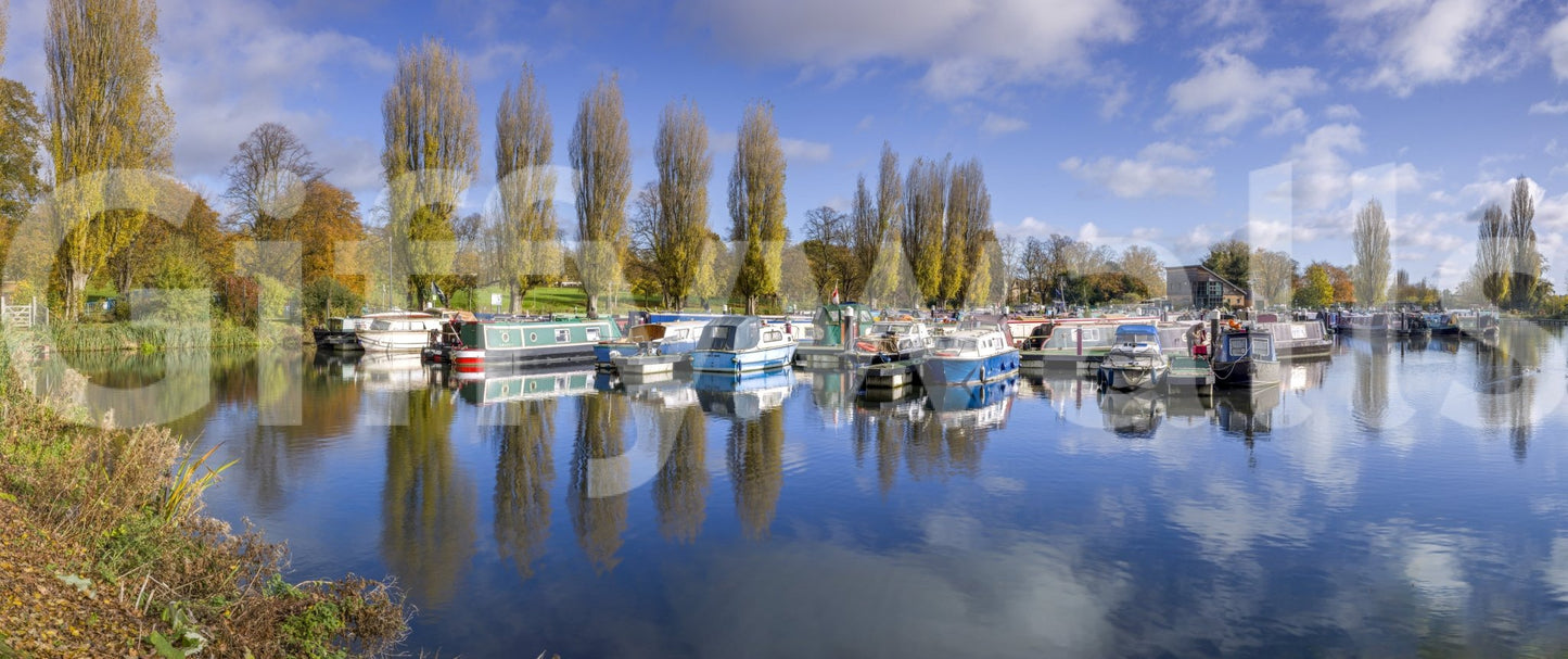 Waterfront wall mural with docked sailboats and sky.

