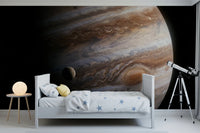 A telescope and crisp white bed sit dramatically against this swirling planet wall mural