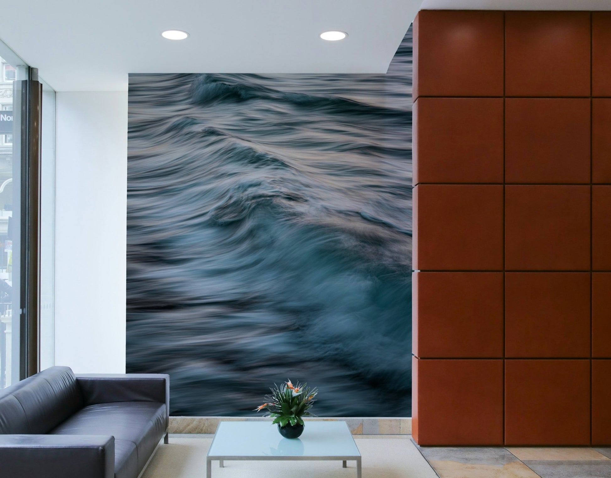A graceful wave motion wall mural in cool, natural tones.

