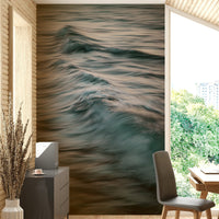 An artistic wave design mural on minimalist wallpaper.

