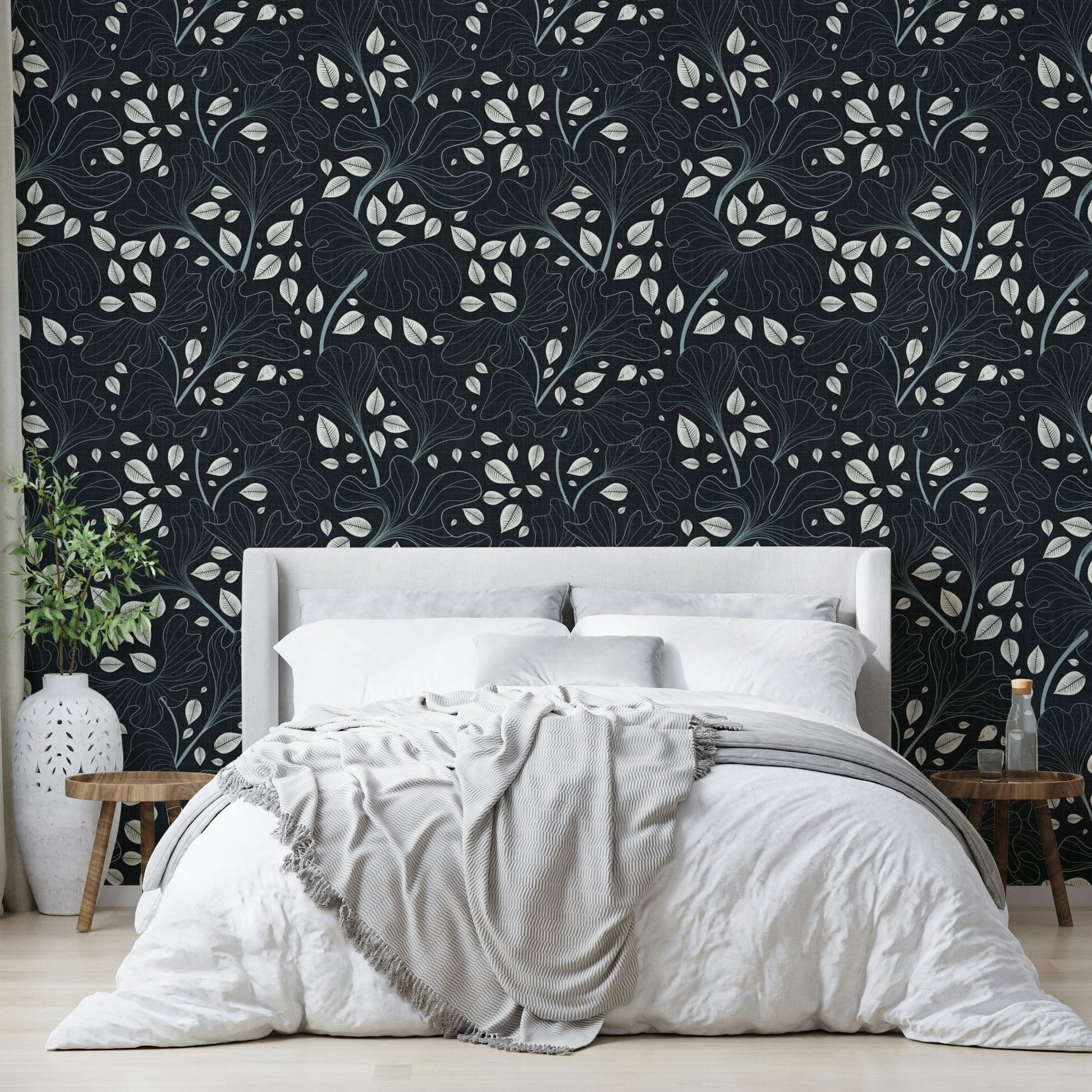 Design featuring leaves outlined in white on a navy blue background.

