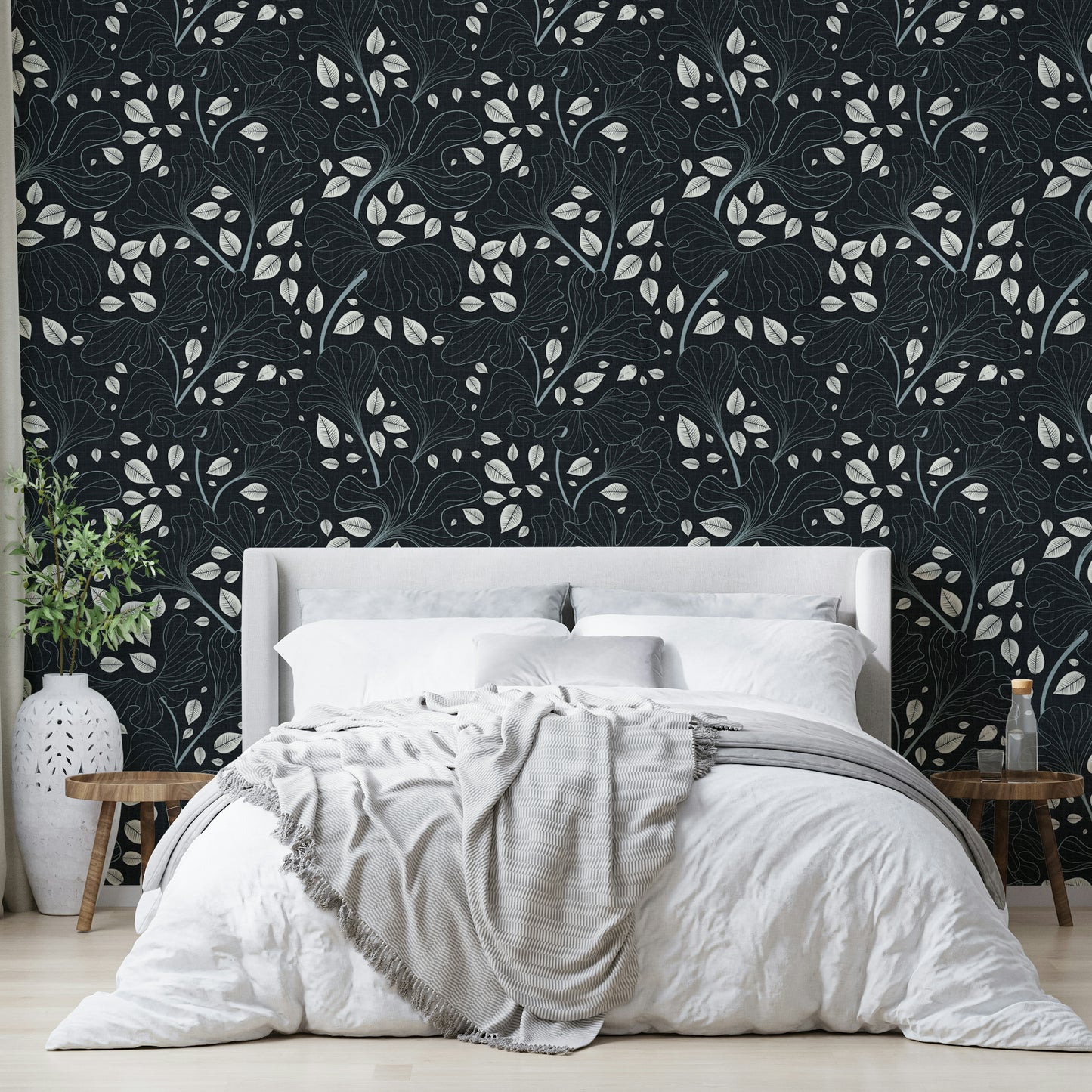 Design featuring leaves outlined in white on a navy blue background.

