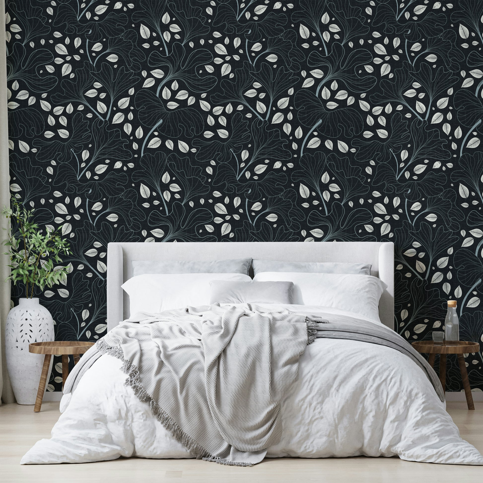 Design featuring leaves outlined in white on a navy blue background.

