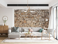 A hand applying the Timeless Stonework elegant stone mural.