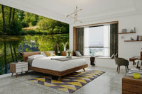 Features a natural landscape with lush greenery, perfectly reflected in calm, still water.
