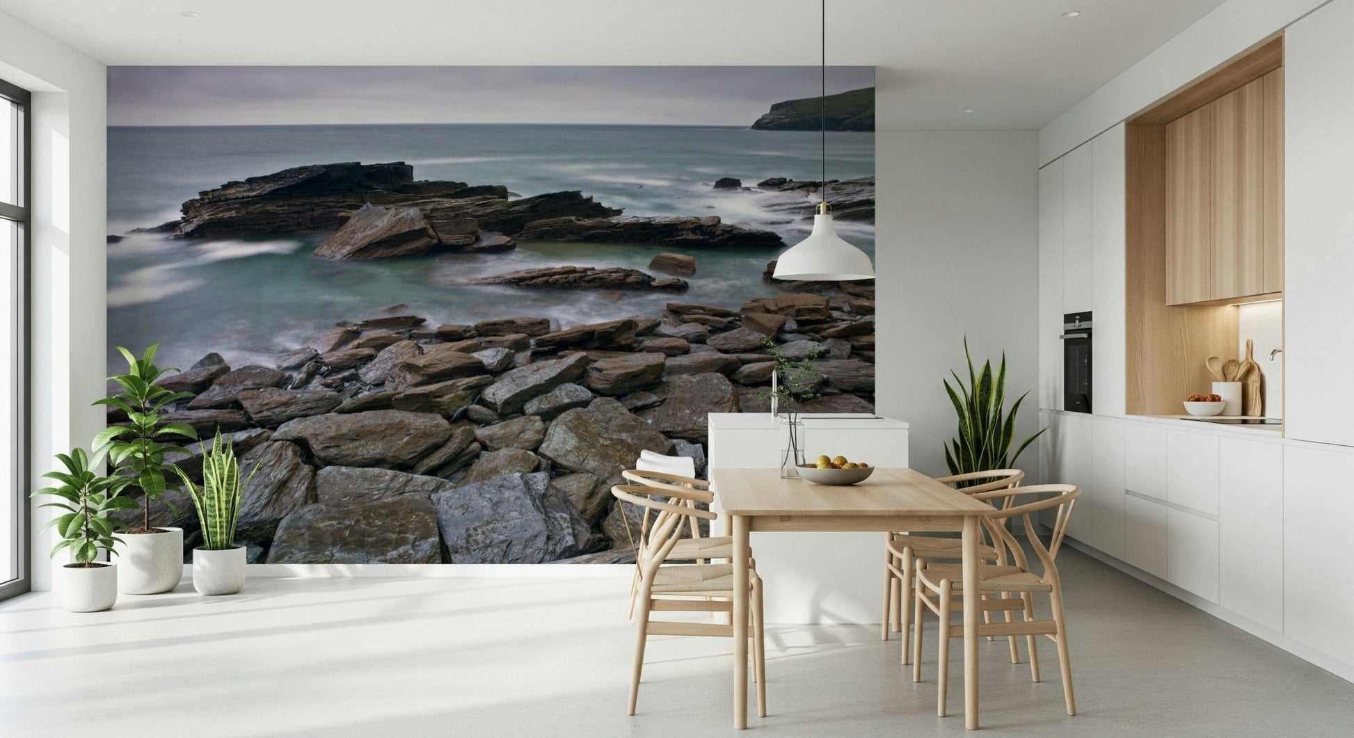 Water flowing around Trebarwith Strand, rocky shore, distant headland.